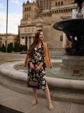 a lady wears a floral printed midi dress with a brown trench coat